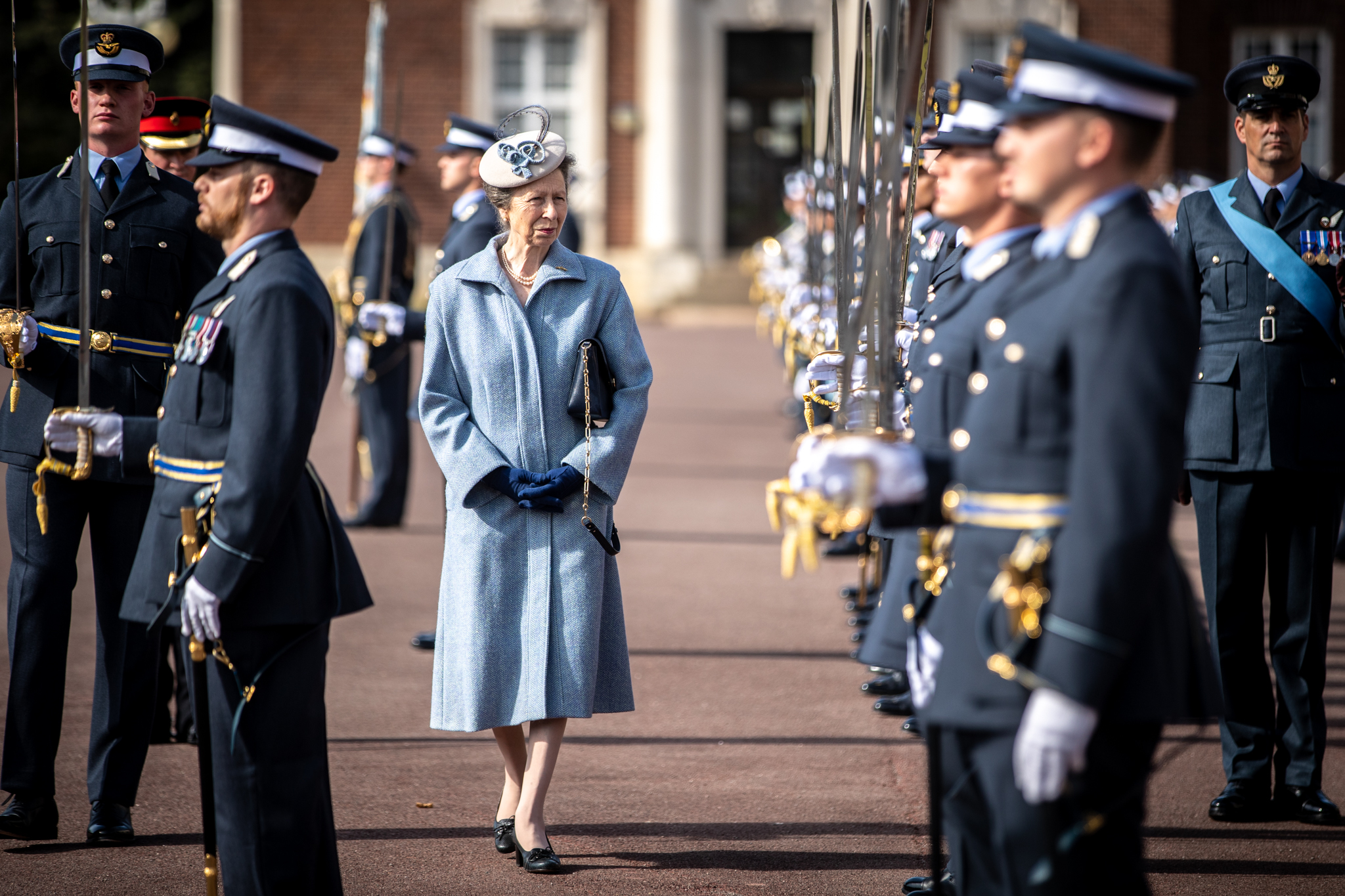 Her Royal Highness talks to personnel with their parade swords.